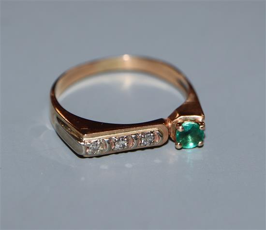 A yellow metal, single stone emerald and channel set three stone diamond ring, size M.